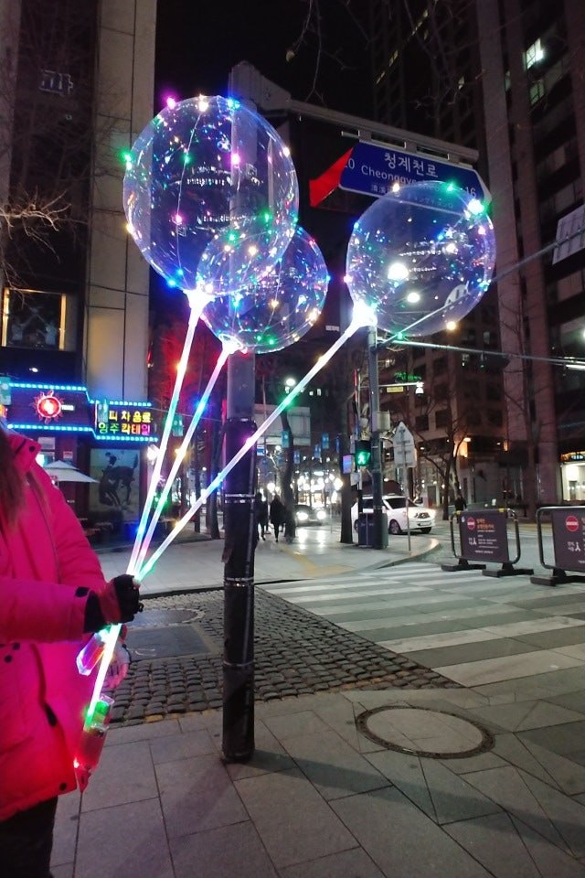Selling LED balloons along Cheonggyecheon, Seoul, December 2017